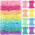 A large package of colorful nylon loom loops in pink, peach, yellow, green, blue, and purple, with smaller bundles of loops arranged to the right.