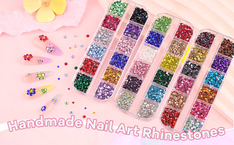 Assortment of multicolor nail art rhinestones in divided containers with decorated nail tips and loose gems scattered