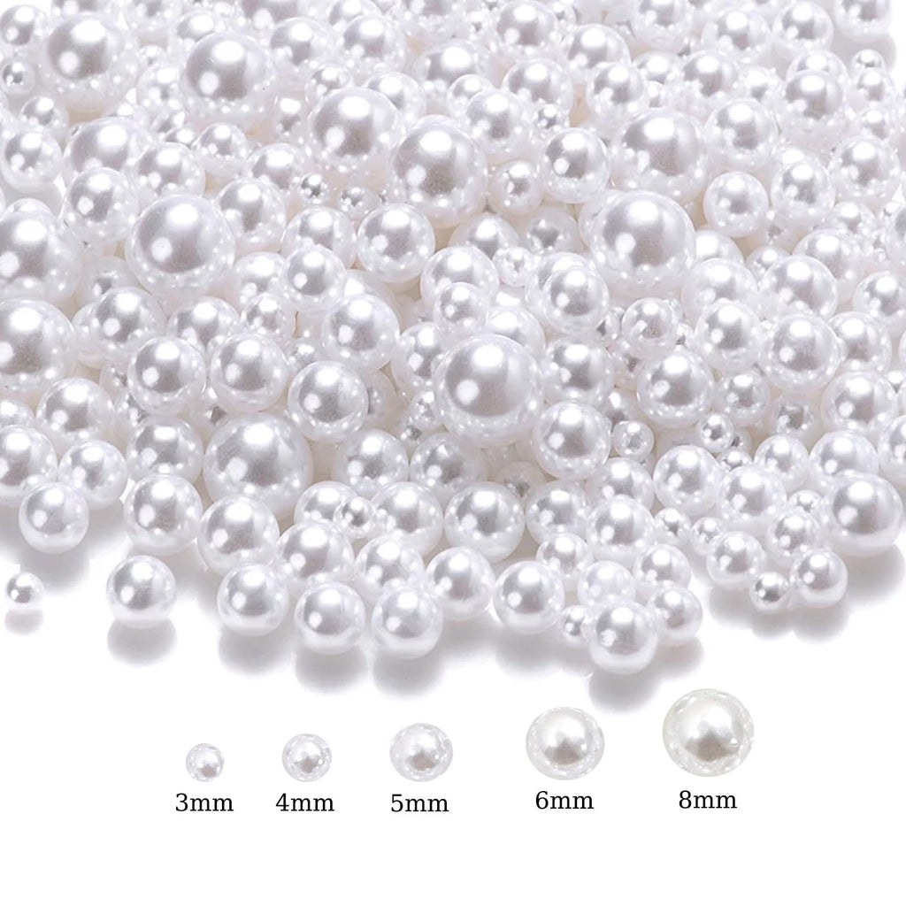 Assortment of white no-hole ABS plastic craft pearls in mixed sizes from 3mm to 8mm, shown on a white background with size labels.