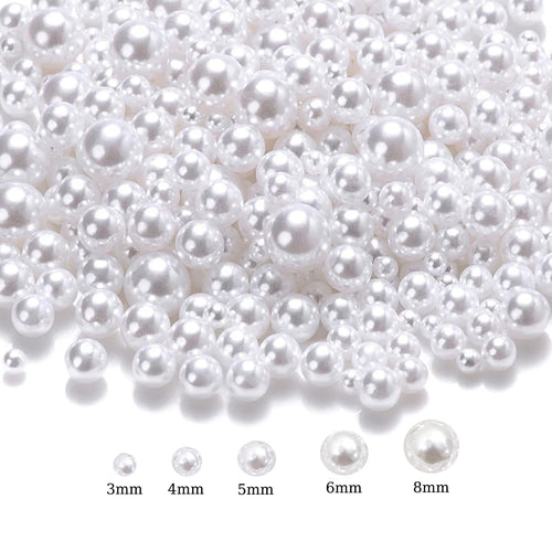 Assortment of white no-hole ABS plastic craft pearls in mixed sizes from 3mm to 8mm, shown on a white background with size labels.