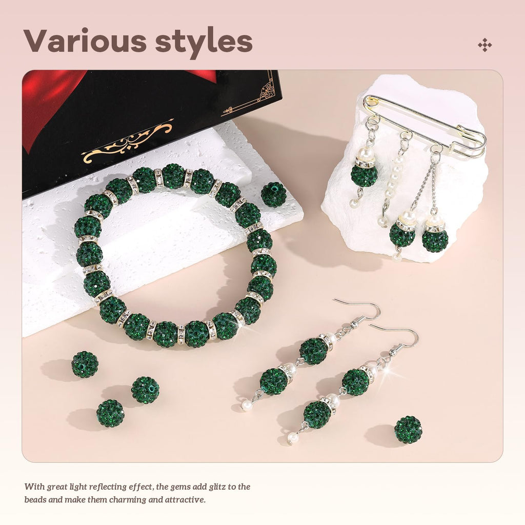 Dark green rhinestone beads arranged as a bracelet and earrings, with loose beads scattered.