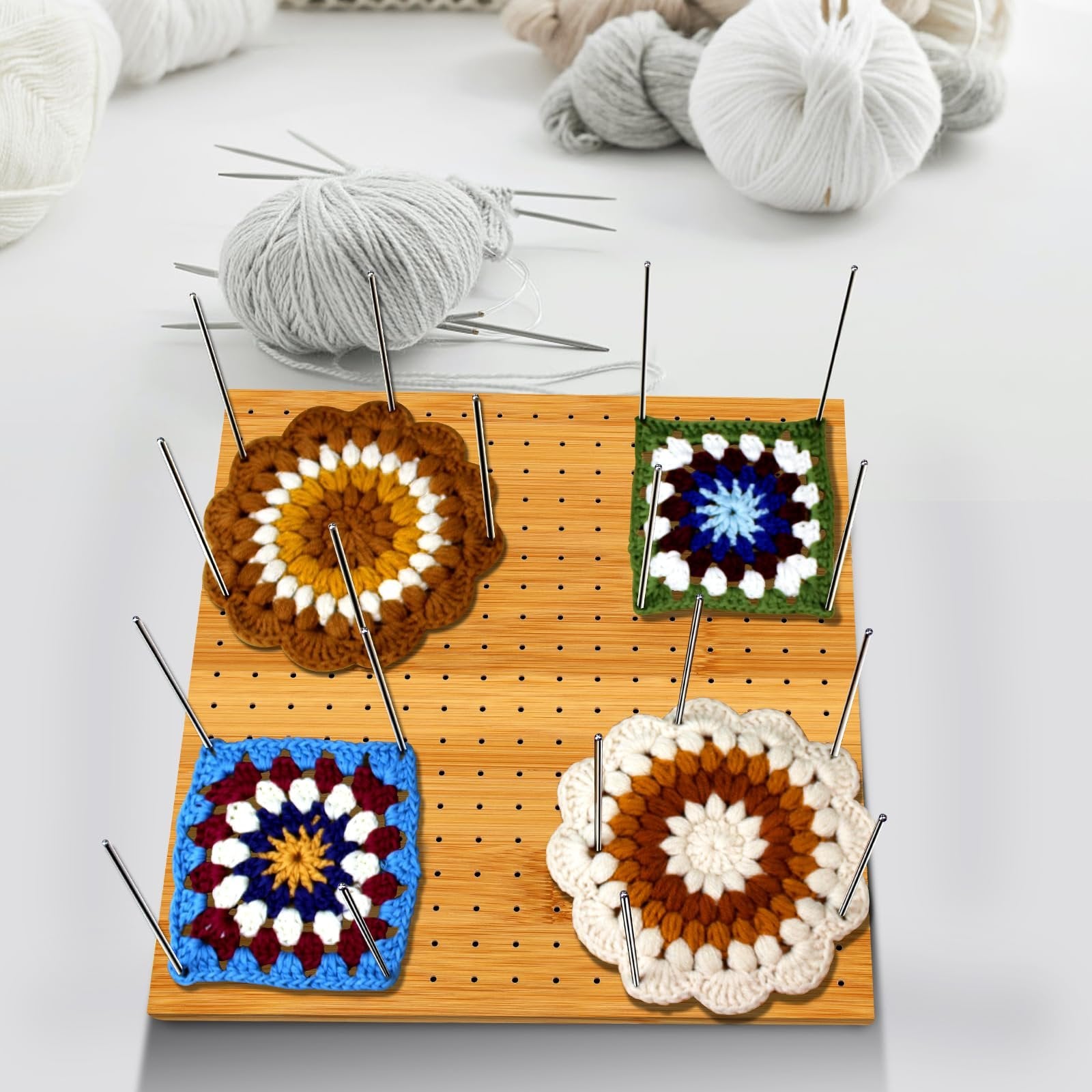 Bamboo blocking board with steel pins holding crocheted granny squares, with yarn and knitting needles in background.