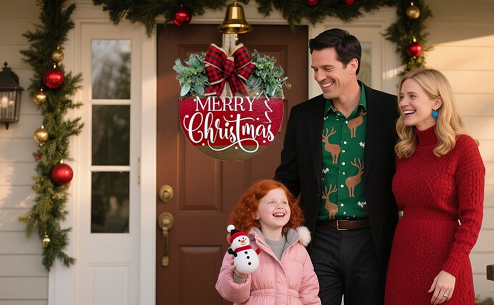 Family smiling on porch with a Merry Christmas hanging sign and holiday decorations