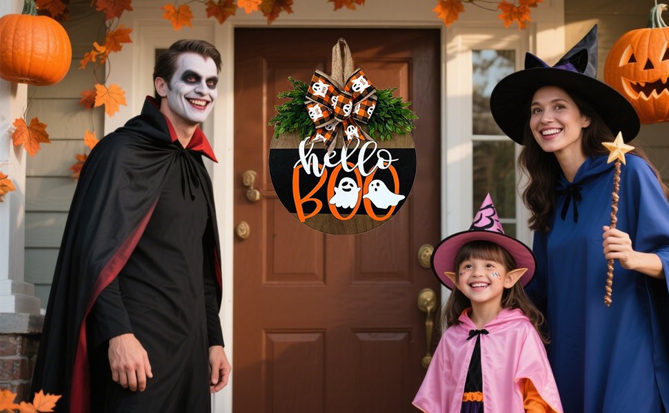 Family in Halloween costumes by a door decorated with a "Hello Boo" sign and pumpkins