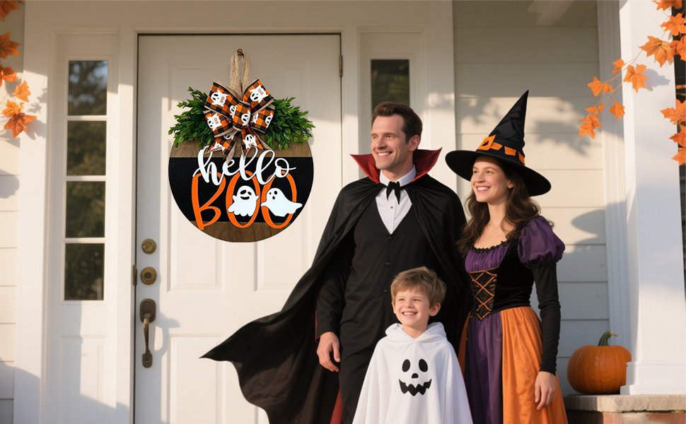 Family in Halloween costumes posing with a round 'Hello Boo' hanging door sign decorated with ghosts and a bow.