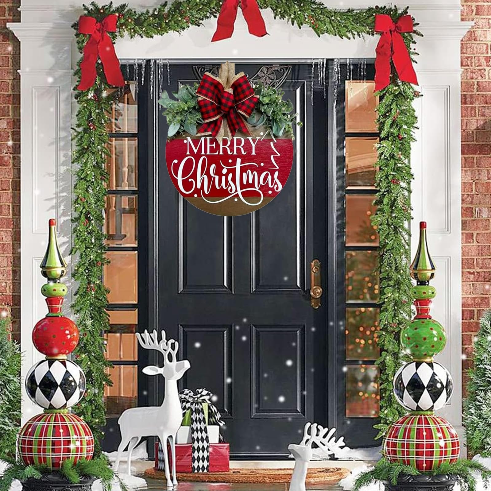 Round wooden Merry Christmas sign with red buffalo plaid bow and green eucalyptus leaves hanging on a black door decorated with Christmas garlands.