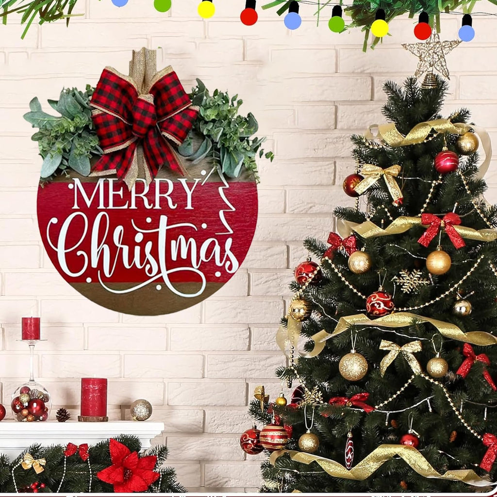 Wooden Merry Christmas hanging sign with plaid bow and greenery, displayed next to a decorated Christmas tree.