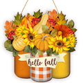 Fall welcome sign with sunflowers, pumpkins, leaves, and berries, featuring a banner that says 'hello fall'.
