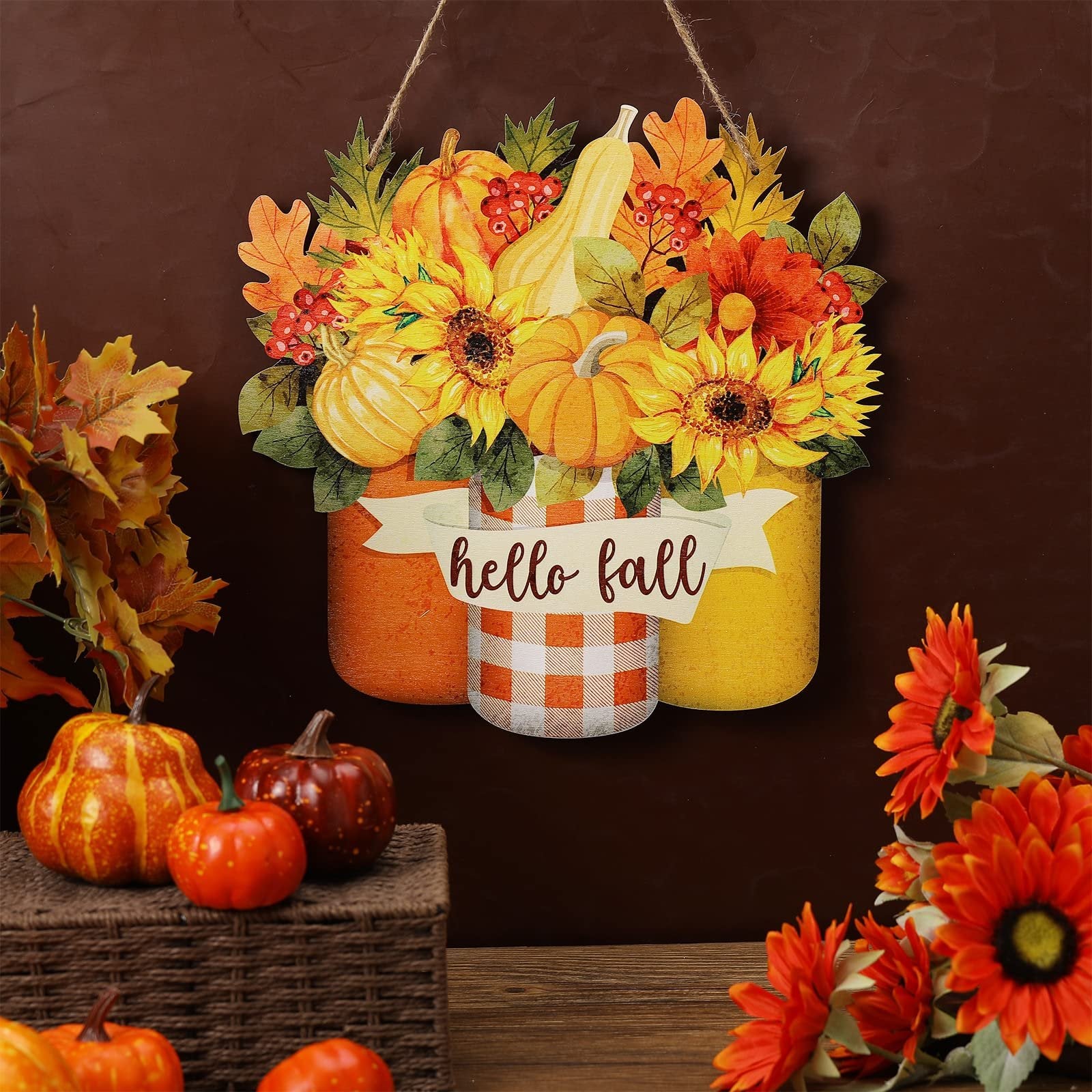 Hanging fall welcome sign with sunflowers, pumpkins, and maple leaves, featuring a 'hello fall' banner.