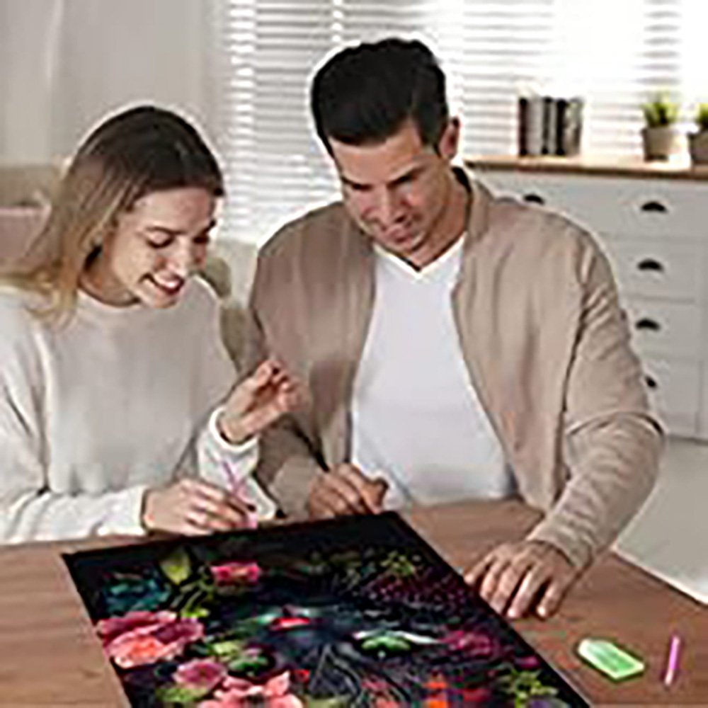 Couple working on a Starry Night 5D diamond painting kit at a table, with tools and canvas visible.