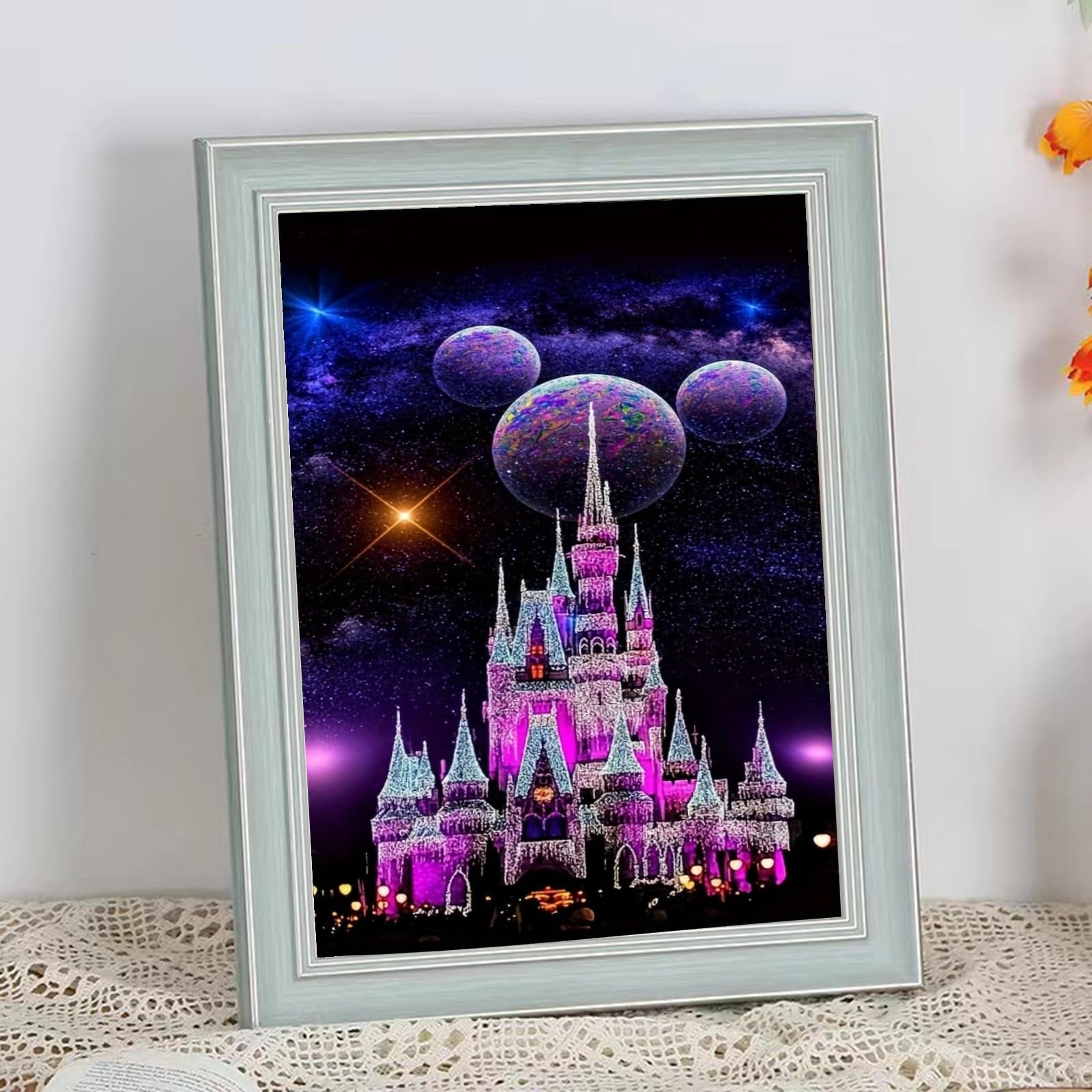 Diamond art painting of a brightly lit castle against a starry night sky with three planets.