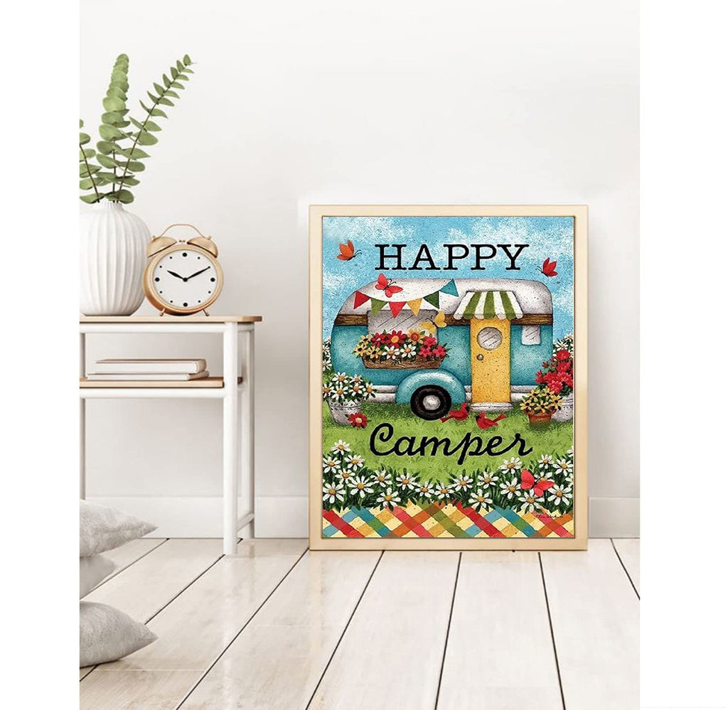 Diamond painting kit featuring a teal camper with flowers and the words Happy Camper, framed and displayed on a shelf.