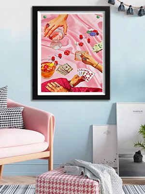 Diamond painting of hands playing cards and holding drinks with money and dice scattered on pink satin fabric.