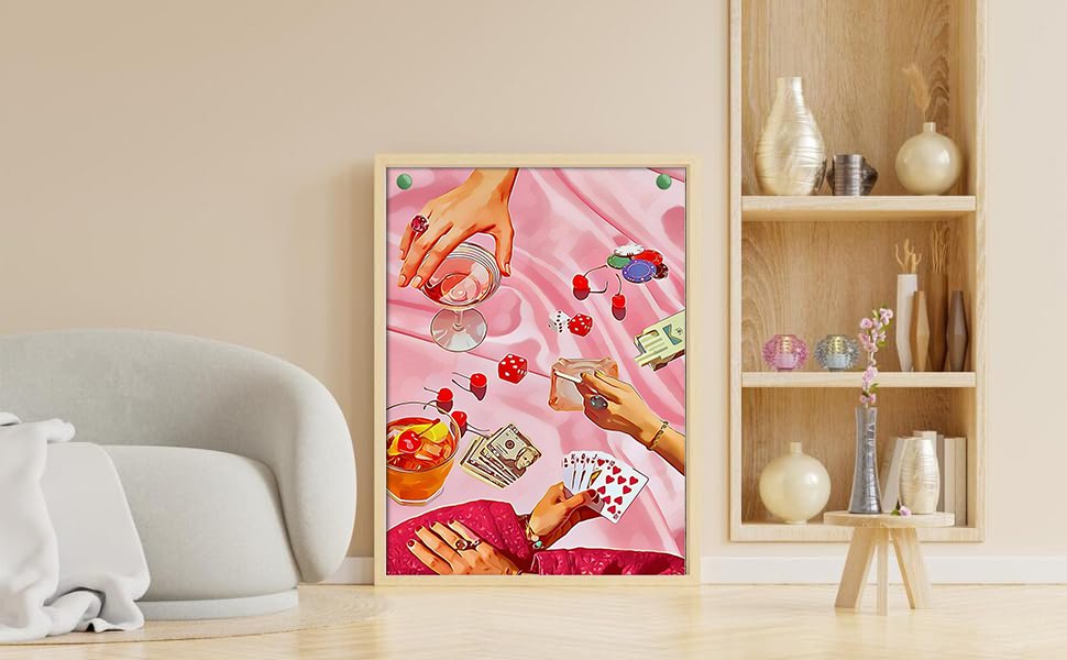 Diamond painting kit art showing hands playing cards, dice, poker chips, and drinks on pink satin.