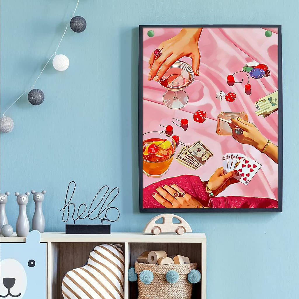 Diamond painting artwork depicting hands playing cards, dice, and drinks on a pink satin cloth.