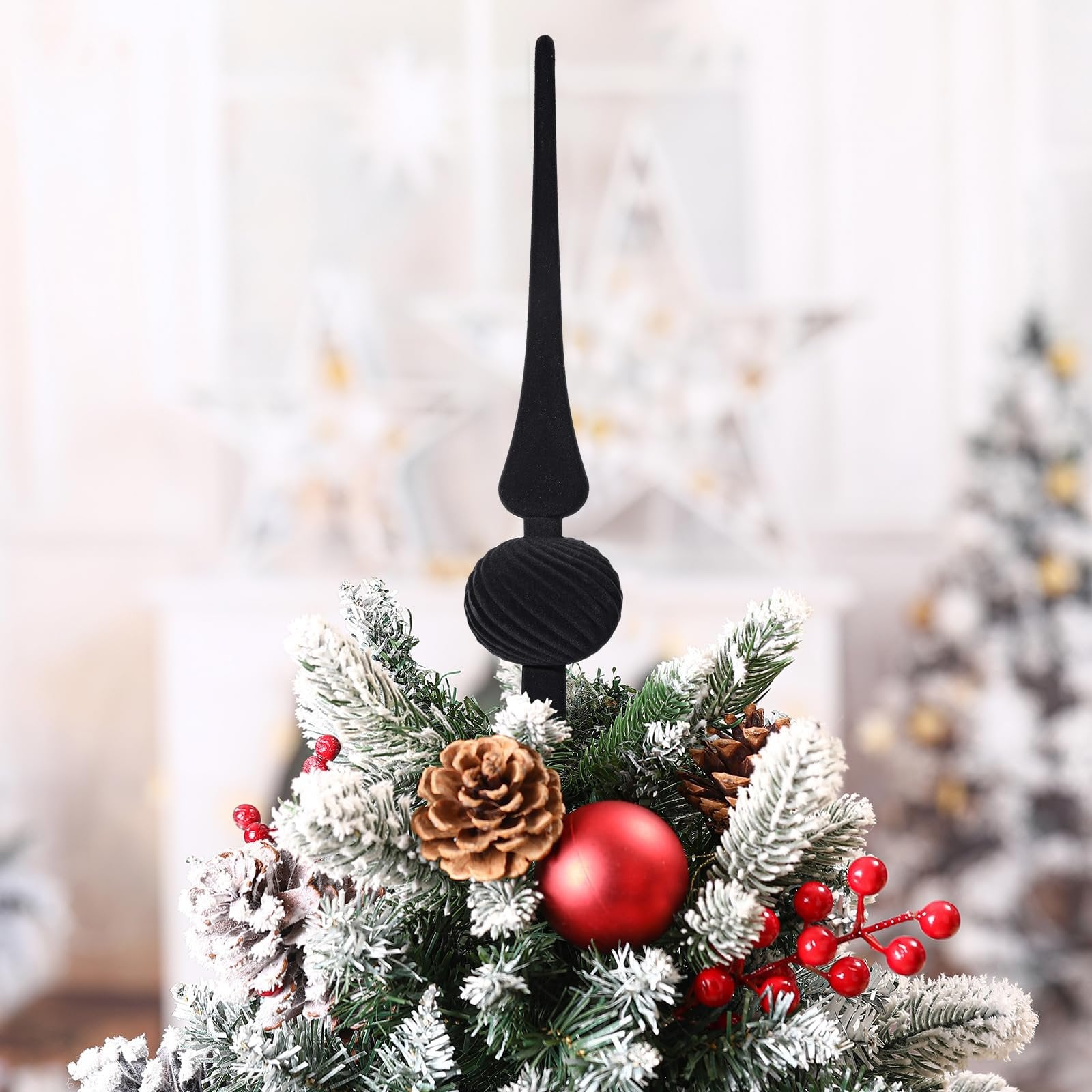 Black velvet finial Christmas tree topper with spherical ornament, decorated with pine cones and red berries.