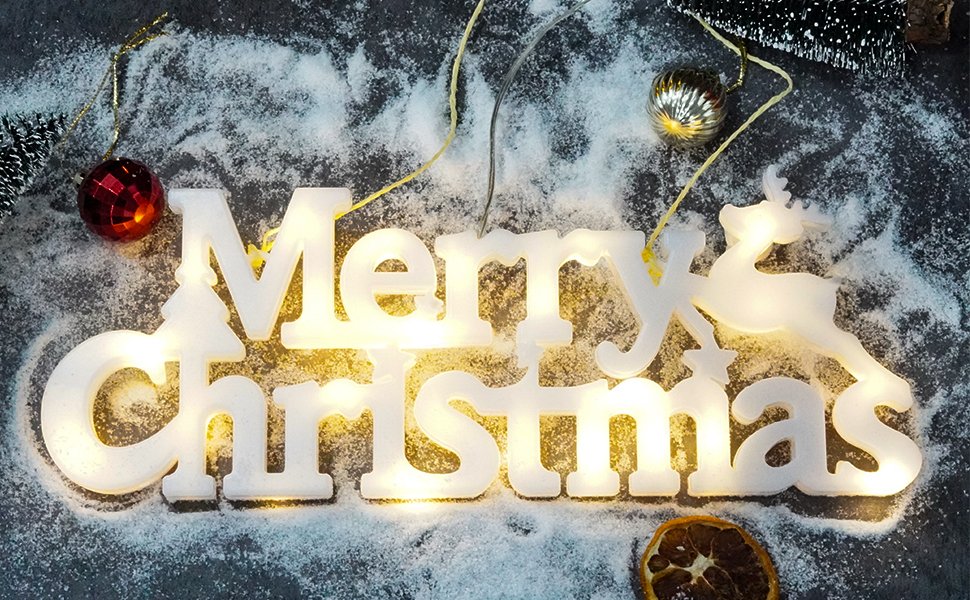 Lighted Merry Christmas sign with reindeer and trees, decorated with faux snow and ornaments.