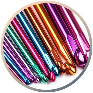 Close-up of a set of multicolor aluminum crochet hooks in various sizes, angled view.