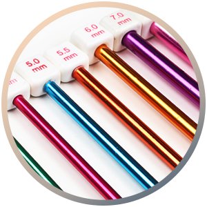 Close-up of a set of multicolor aluminum Tunisian crochet hooks with size markings in millimeters.