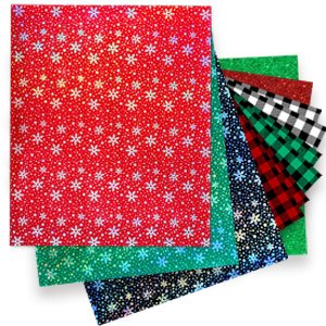 Stack of 11 Christmas buffalo plaid heat transfer vinyl sheets in various colors and snowflake patterns.