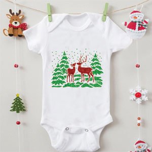 White baby onesie with a Christmas graphic of two deer and green trees with falling snow