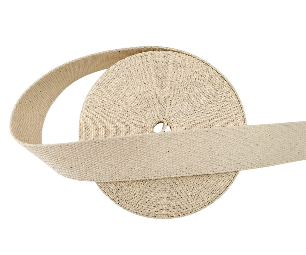Roll of natural cotton webbing, 1.5 inch wide, with a section unrolled.