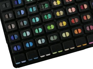 Close-up of a 112-color gouache paint set in twin jelly cups, showing a grid of open and closed paint compartments.
