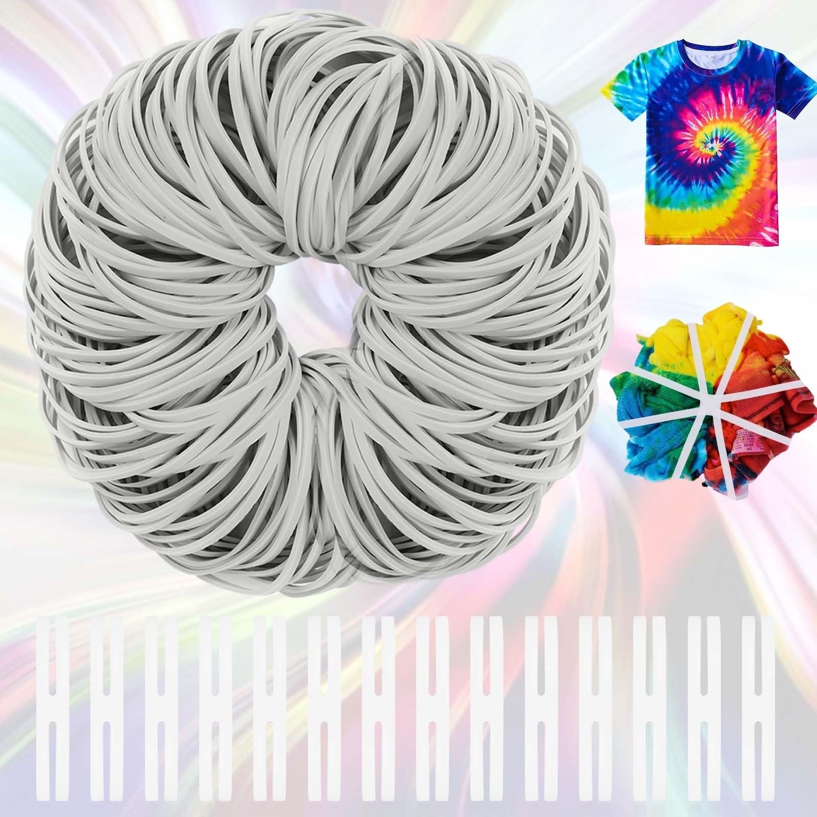 Large bundle of white rubber bands with a tie-dyed t-shirt and fabric swatch in the background