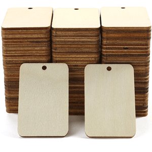 Stack of unfinished wood rectangle cutouts with pre-drilled holes, two in foreground