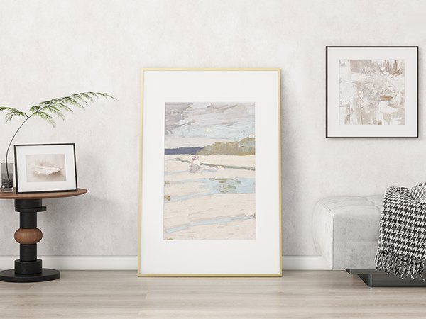Gold 11x14 picture frame with mat displaying abstract art, placed on a floor next to a side table and sofa.