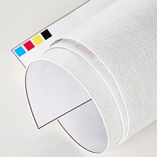 Rolled white canvas with CMYK color squares in the corner, close-up