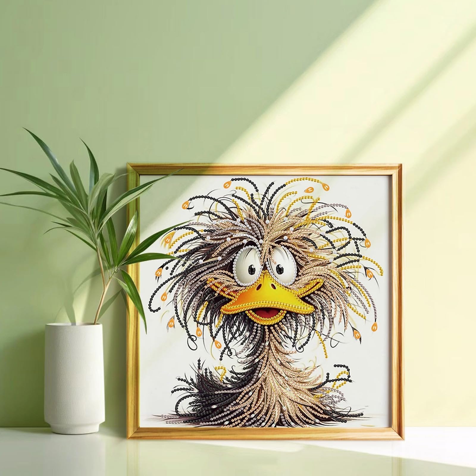 Framed diamond art kit featuring a cartoon duck with messy, colorful feathers and large eyes.