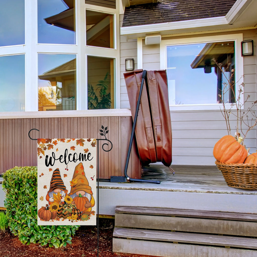 Fall garden flag with two gnomes, pumpkins, and leaves, displaying the word 'Welcome'.