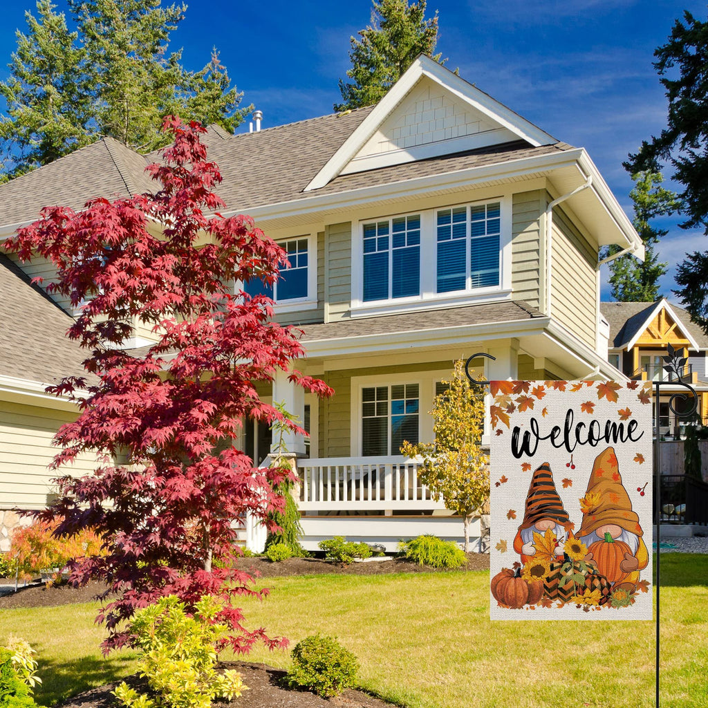 Fall garden flag with two gnomes, pumpkins, sunflowers, and autumn leaves, displaying the word 'Welcome'.