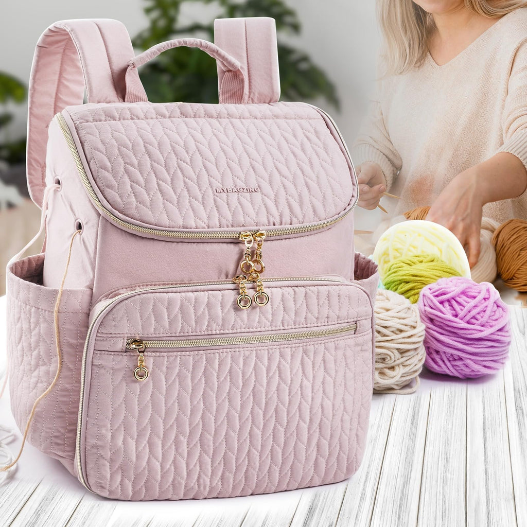 Pink quilted knitting backpack with gold zippers and charms, shown with yarn and a person knitting in the background.