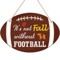 Brown football-shaped hanging sign with text 'It's not Fall without FOOTBALL', autumn leaves and acorns.
