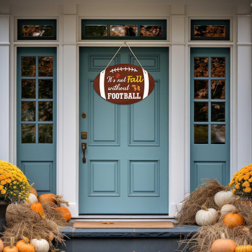 Football shaped fall hanging sign with text 'It's not Fall without FOOTBALL' displayed on a blue front door with autumn decorations.