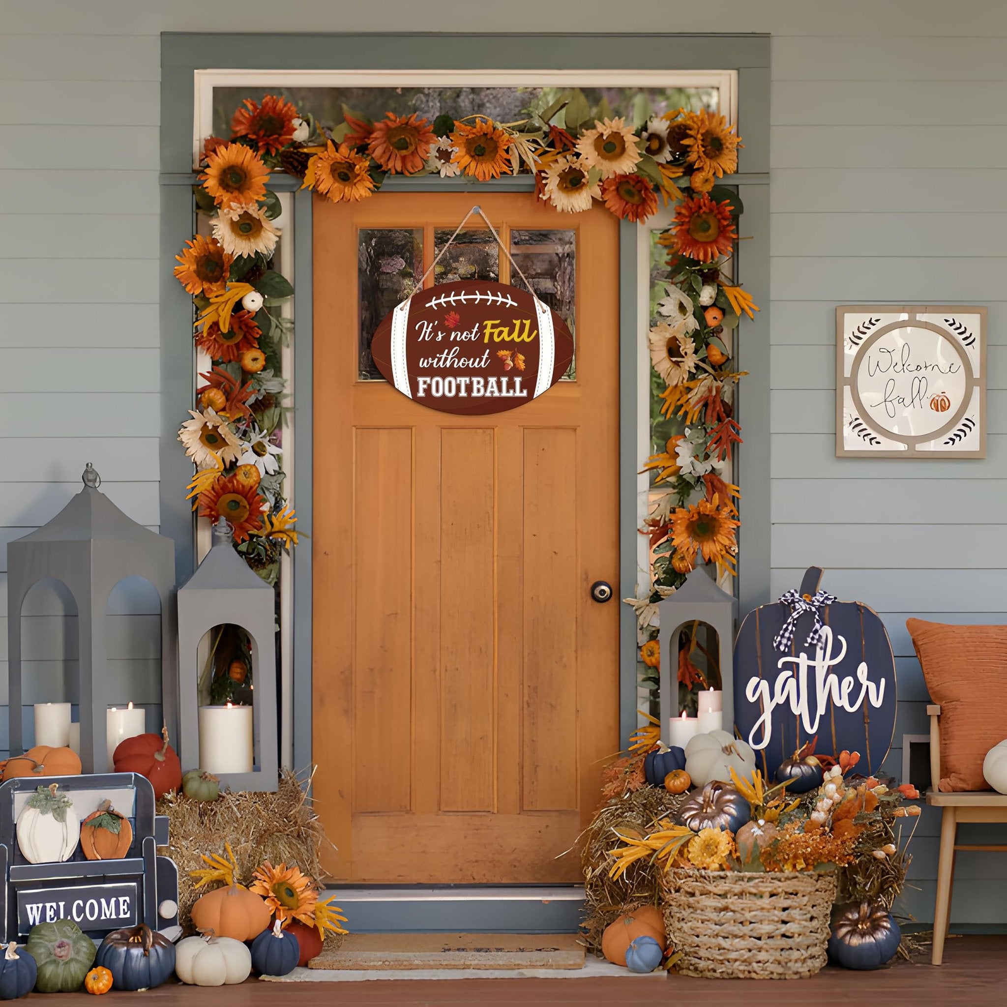 Front door decorated for fall with a football-shaped sign saying 'It's not Fall without FOOTBALL'.