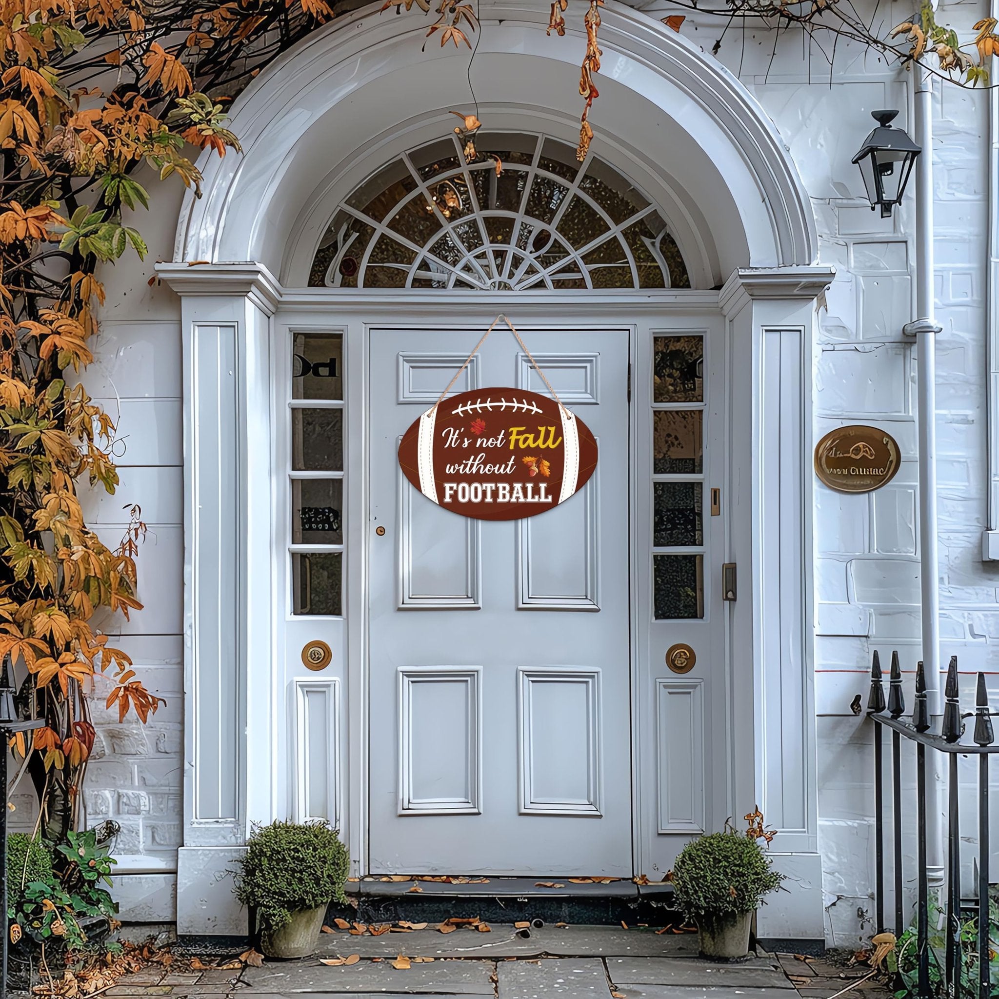 Football shaped fall hanging sign with text 'It's not Fall without FOOTBALL' hanging on a white door.