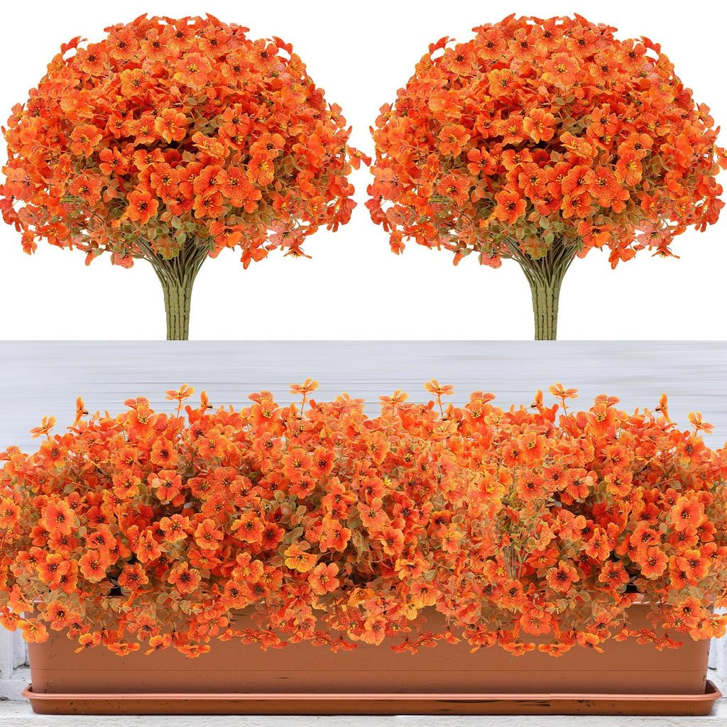 Two bunches of artificial orange flowers with green leaves and one planter filled with artificial orange flowers