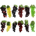 Twelve bunches of artificial grapes in six colors and two sizes, displayed in two rows against a white background.