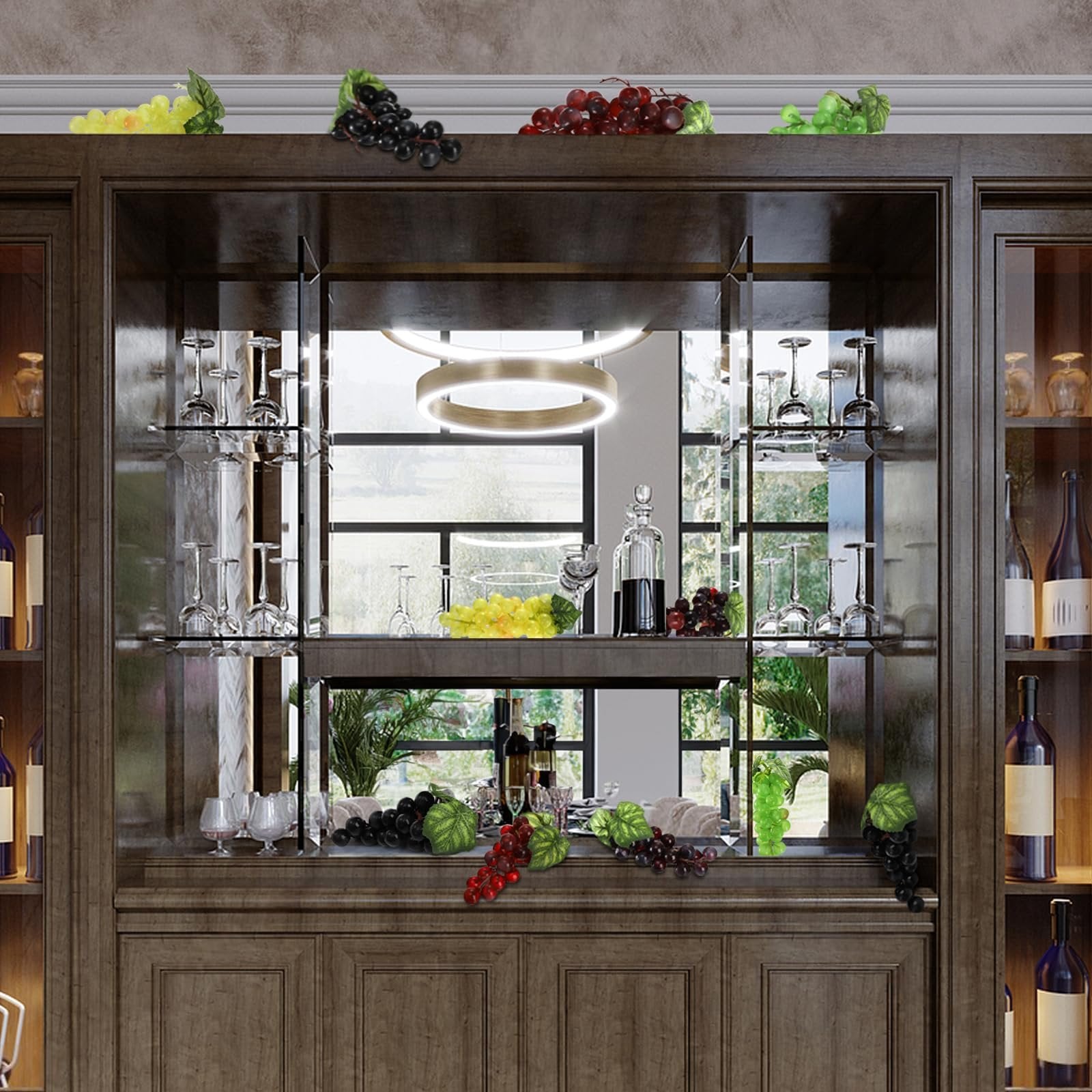 Artificial grapes in various colors and sizes displayed on a wooden bar cabinet with wine glasses and bottles.