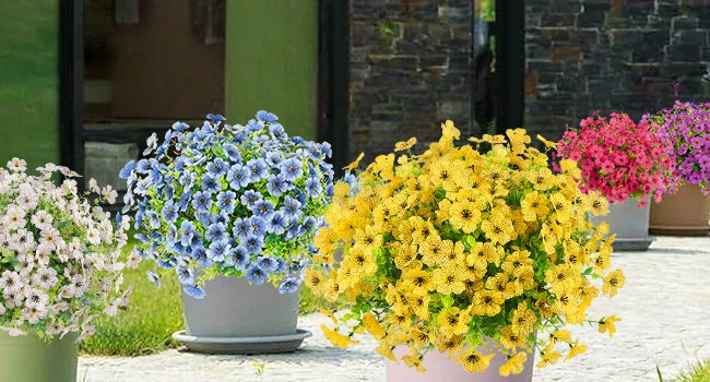 Assortment of artificial daisy flowers in pots, including white, blue, yellow, pink, and purple varieties, displayed outdoors.