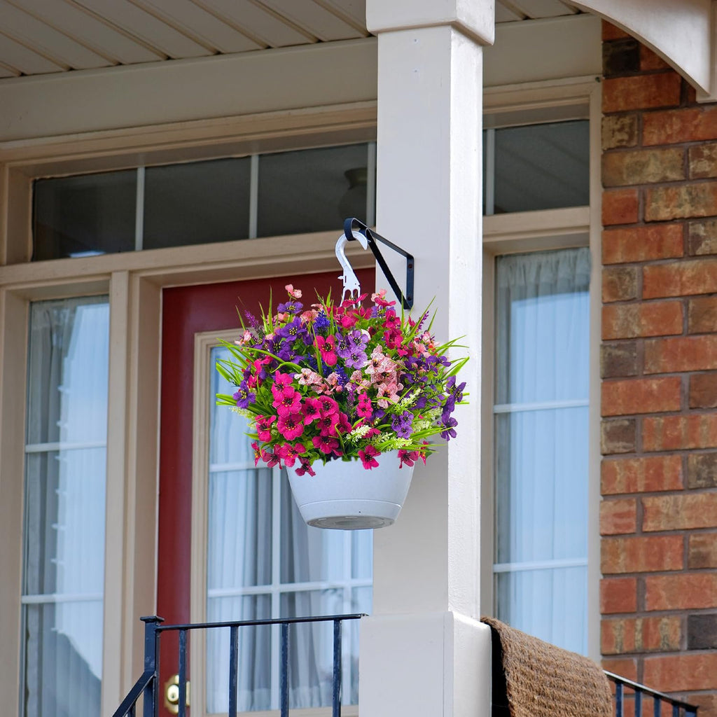 Hanging basket with mixed color artificial flowers on a porch column