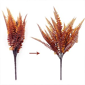 Two artificial fall fern bushes, one compressed and one expanded, on a white background.