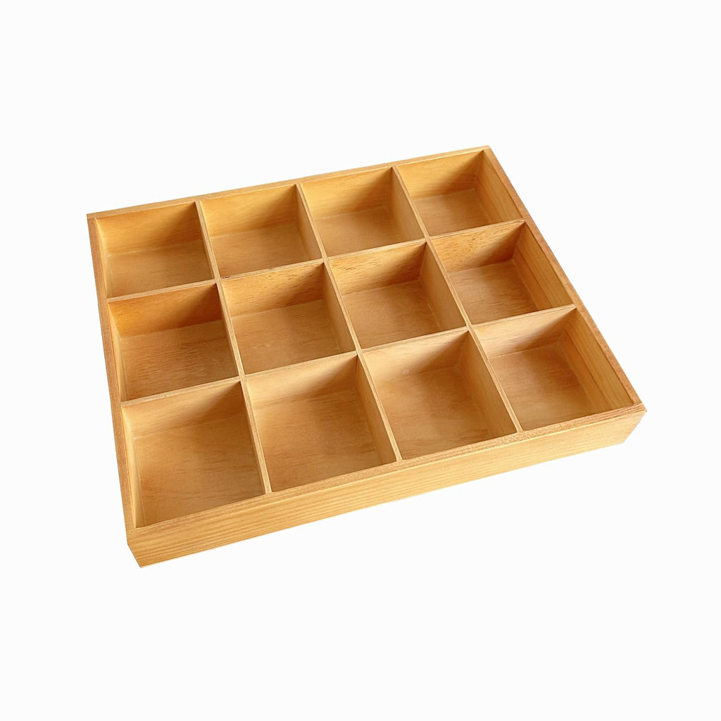 Wooden organizer box with 12 compartments, viewed from a high angle on a white background.