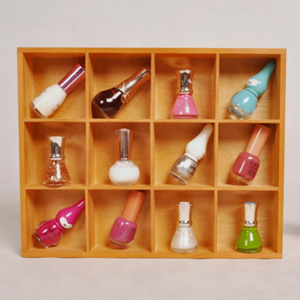 Wooden organizer box with 12 compartments filled with various nail polish bottles, front view.