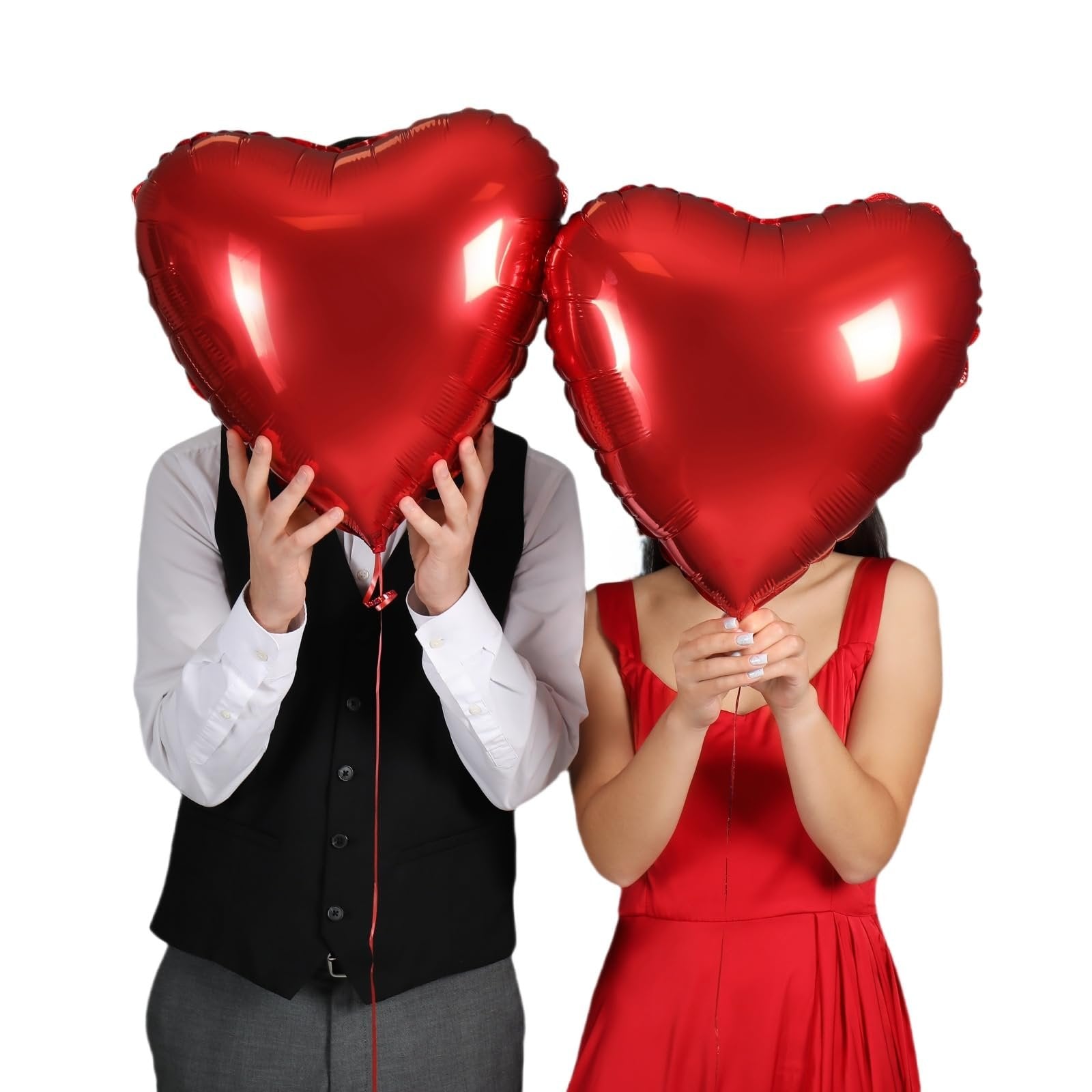 Two people holding large red heart-shaped balloons in front of their faces against a white background.