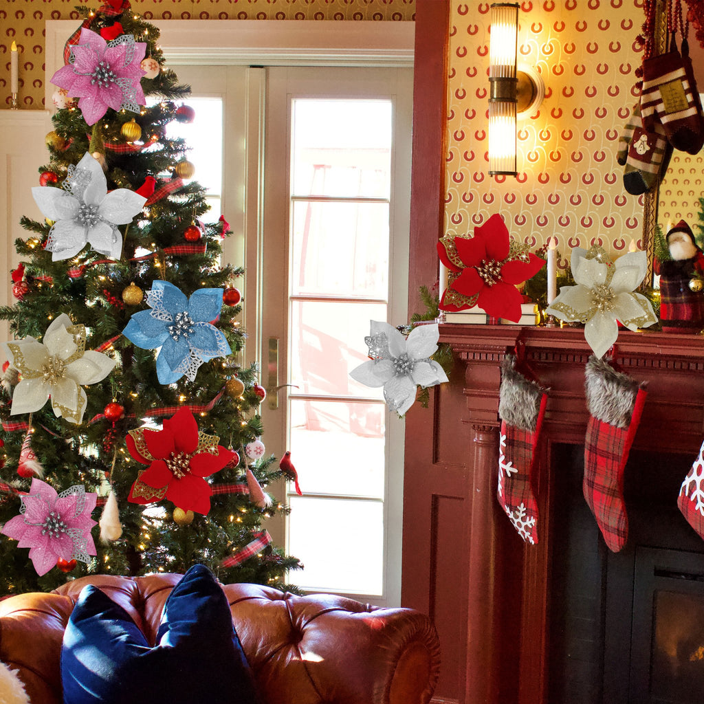 Assortment of glitter poinsettia flowers with metal clips decorating a Christmas tree and fireplace mantel.