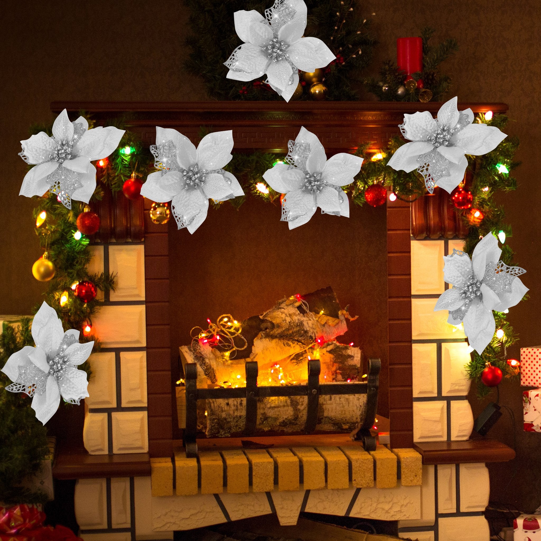 Artificial white poinsettia flowers with glitter and metal clips decorating a Christmas fireplace mantel with garland and lights